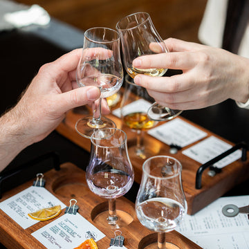 A cheers of whisky glasses