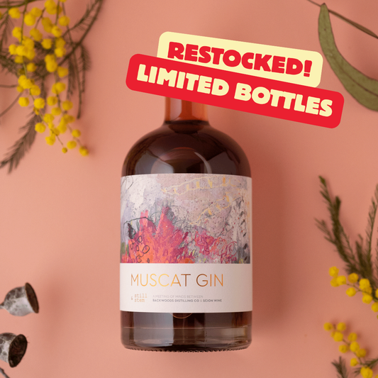 Bottle of Muscat Gin with decorative elements and 'Restocked! Limited Bottles' text on a pink background.